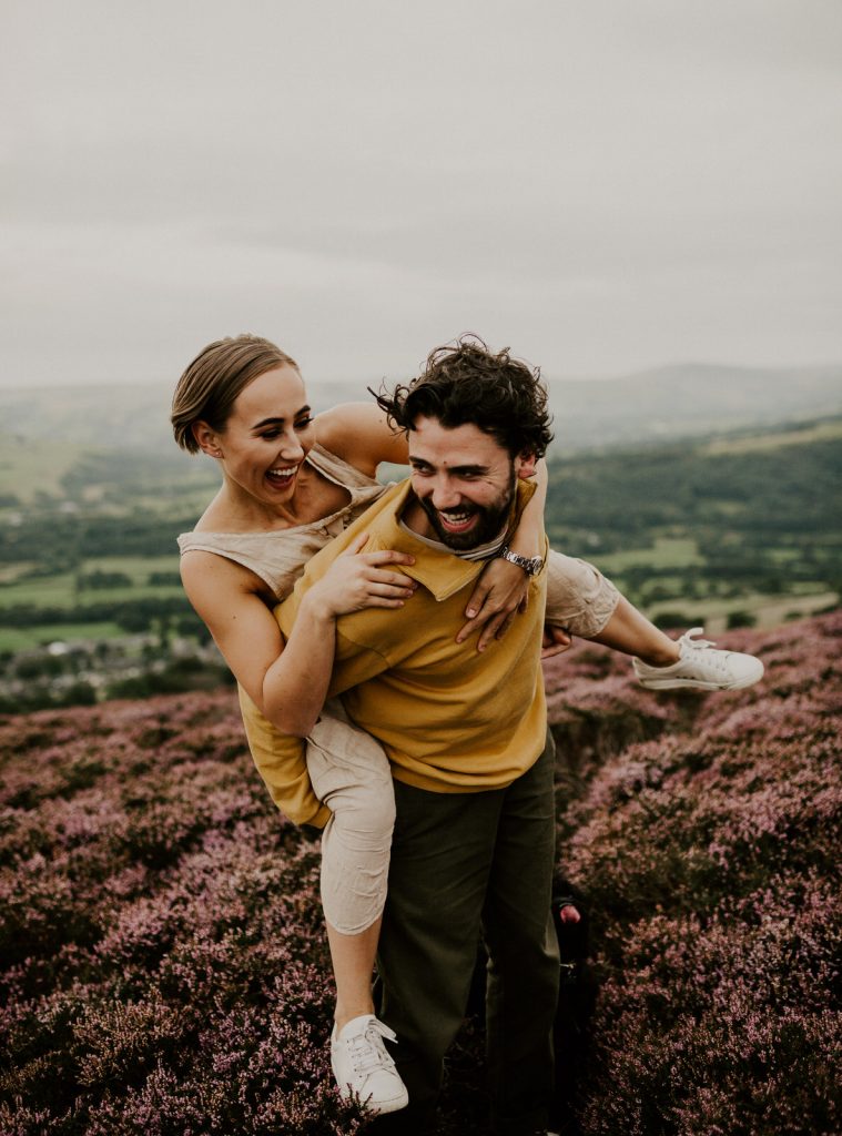 couple laughing on engagement shoot in peak district