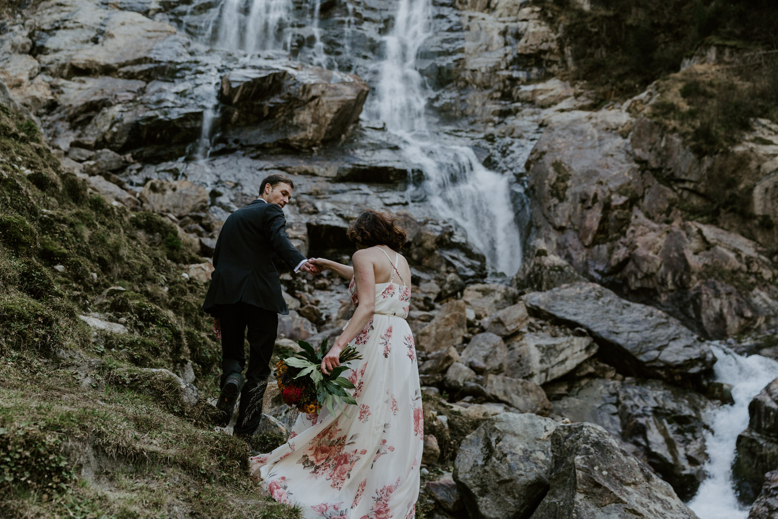 Eloping couple hiking waterfall in Austria