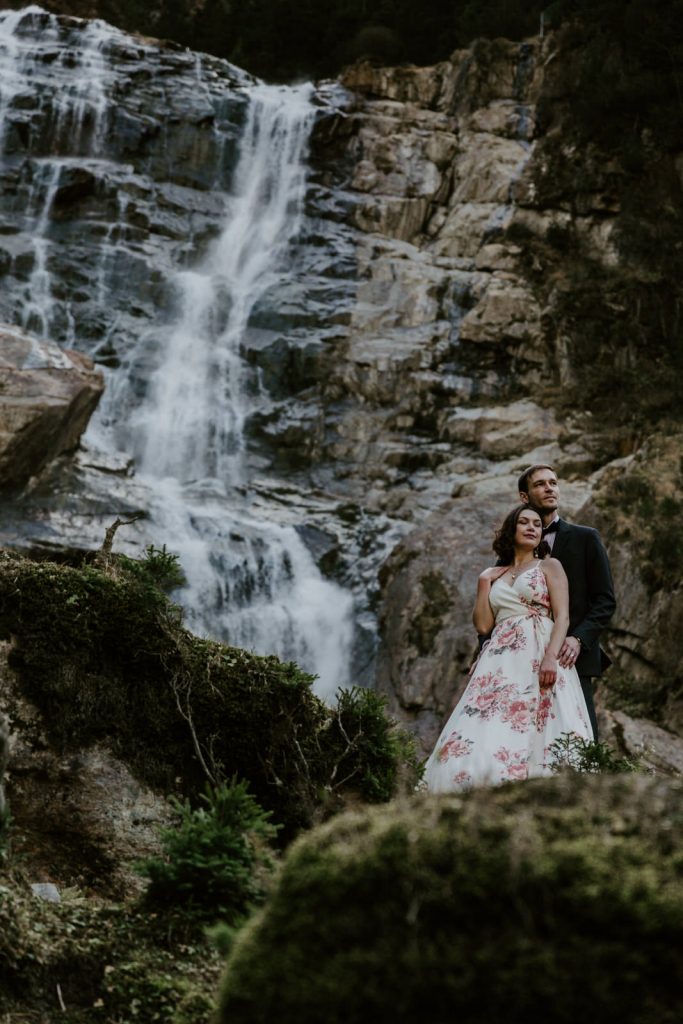 Couple hiking a waterfall on their elopement